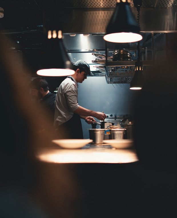 A chef plating a dish in a professional kitchen
