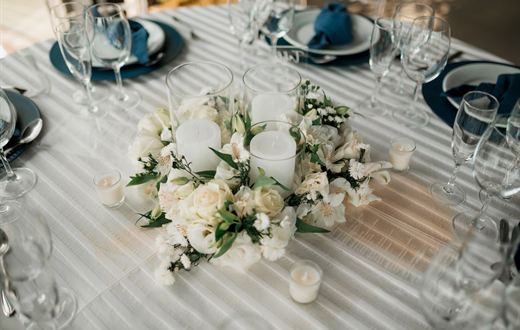 Wedding table centrepiece of white flowers and candles