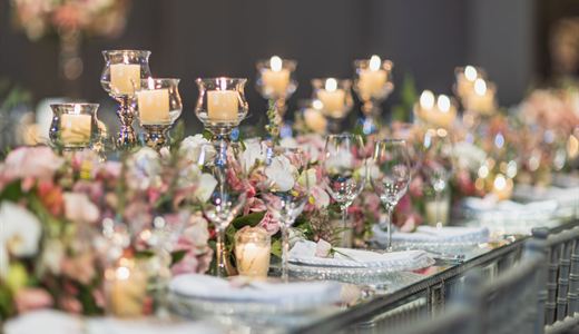 Long table laid with candles and flowers for an event